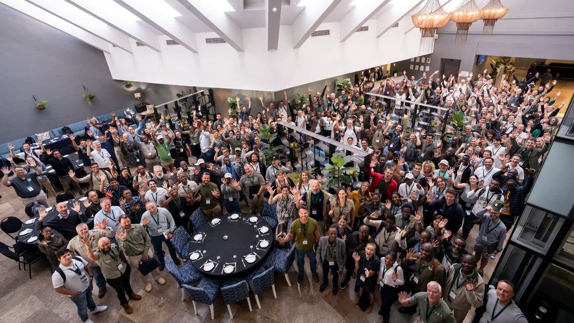 A photograph of attendees of the 2023 EarthRanger User Conference standing together in one room.